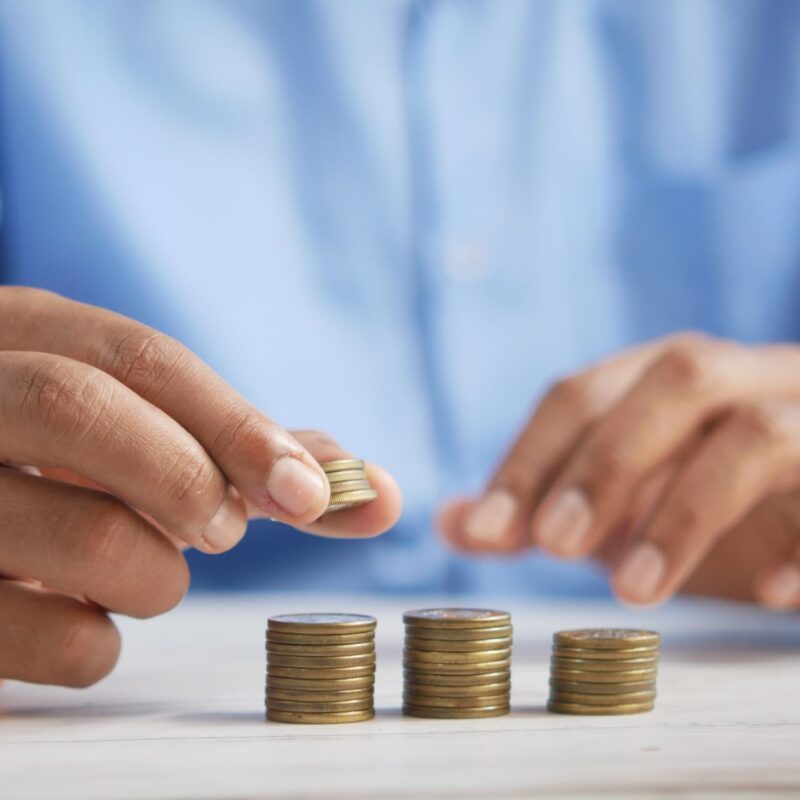 hands creating a pile of coins